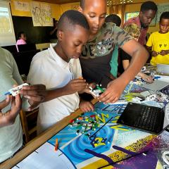 Students at Fruits of Hope Academy assembling mission models