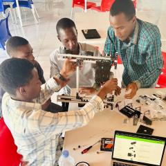 Rwandan students building a robot