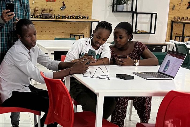 Rwandan students programming a robot