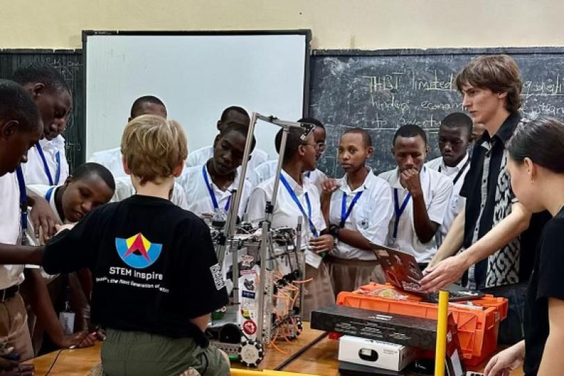Rwandan students in classroom watching a robotics demo