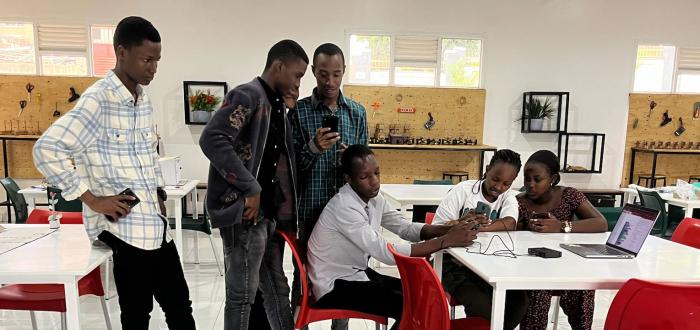 Rwandan students working on programming a robot